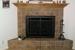 Corner fireplace with ceramic tile and oak mantle